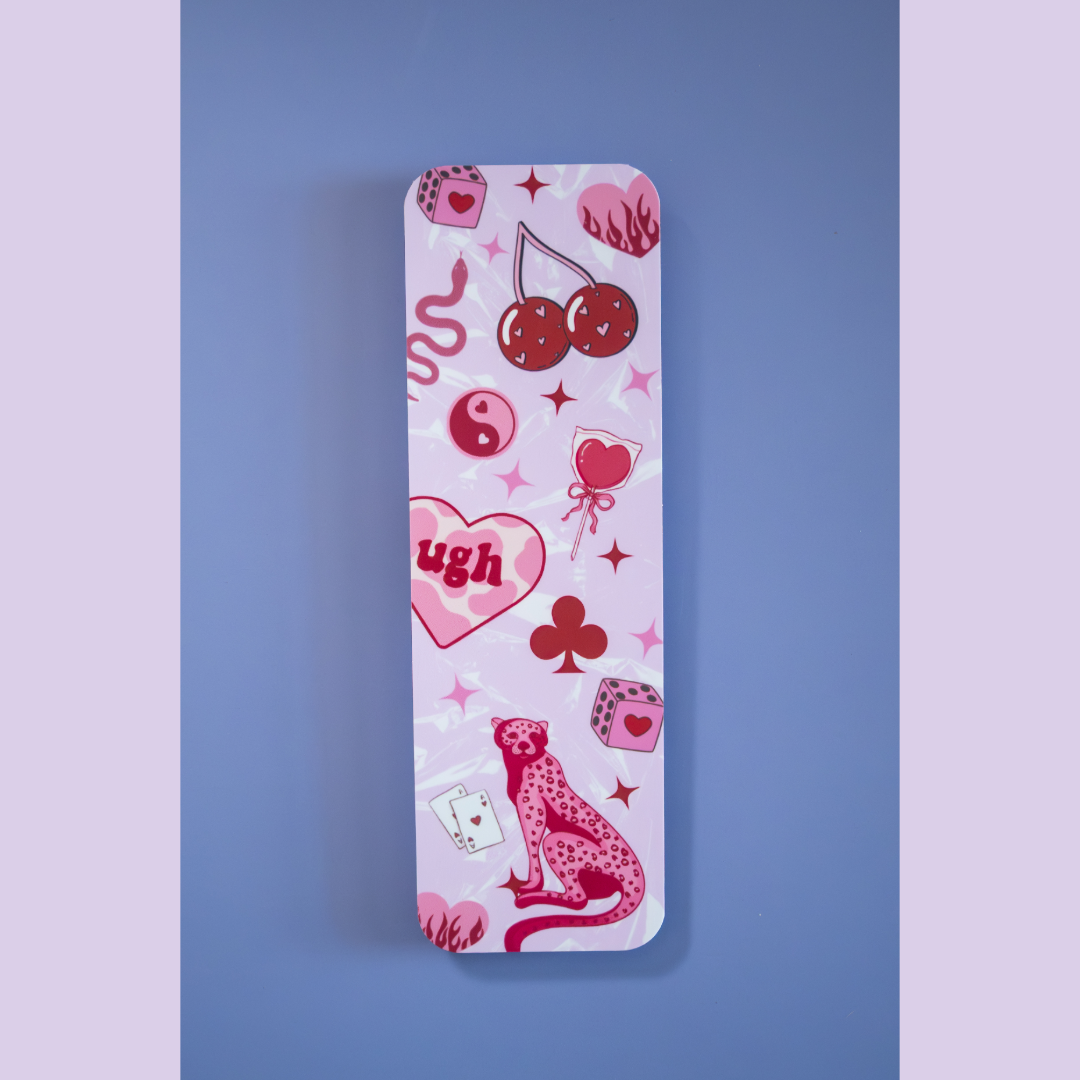 Feral in Pink double-sided matte bookmark by Ink & Static, featuring cherries, dice, a pink cheetah, yin yang, and heart graphics on a pink background