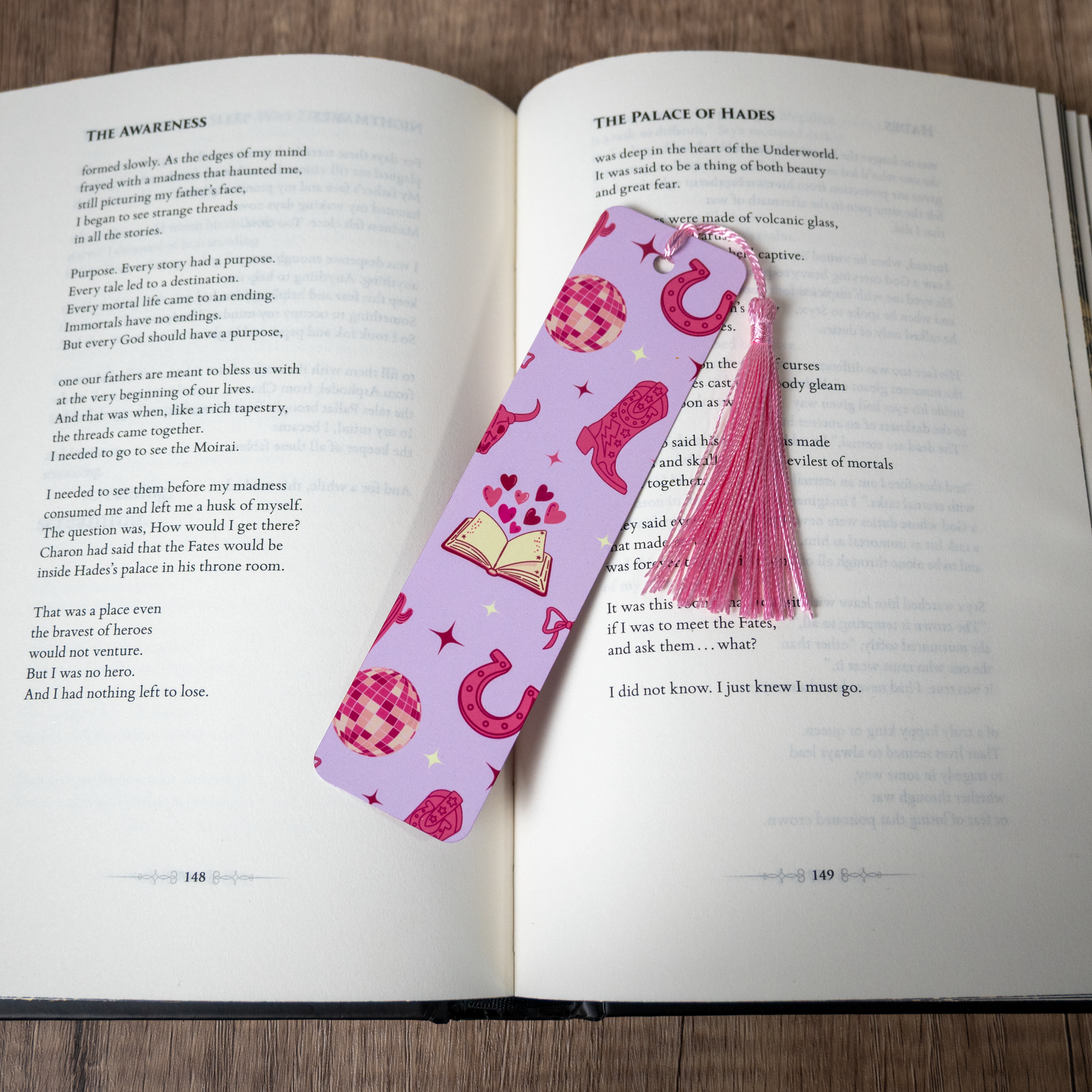 Pink cowgirl bookmark with tassel on an open book
