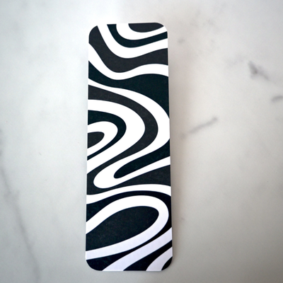 Black and white wavy patterned bookmark on a light gray background
