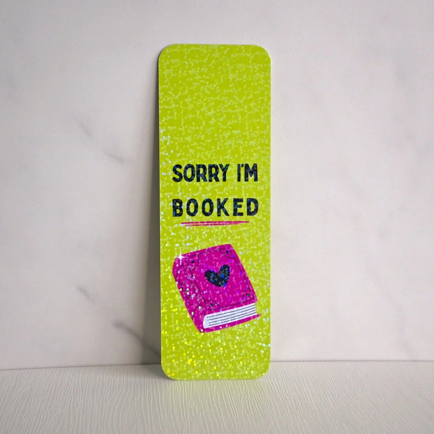 Green book with 'Sorry I'm Booked' text on a white background