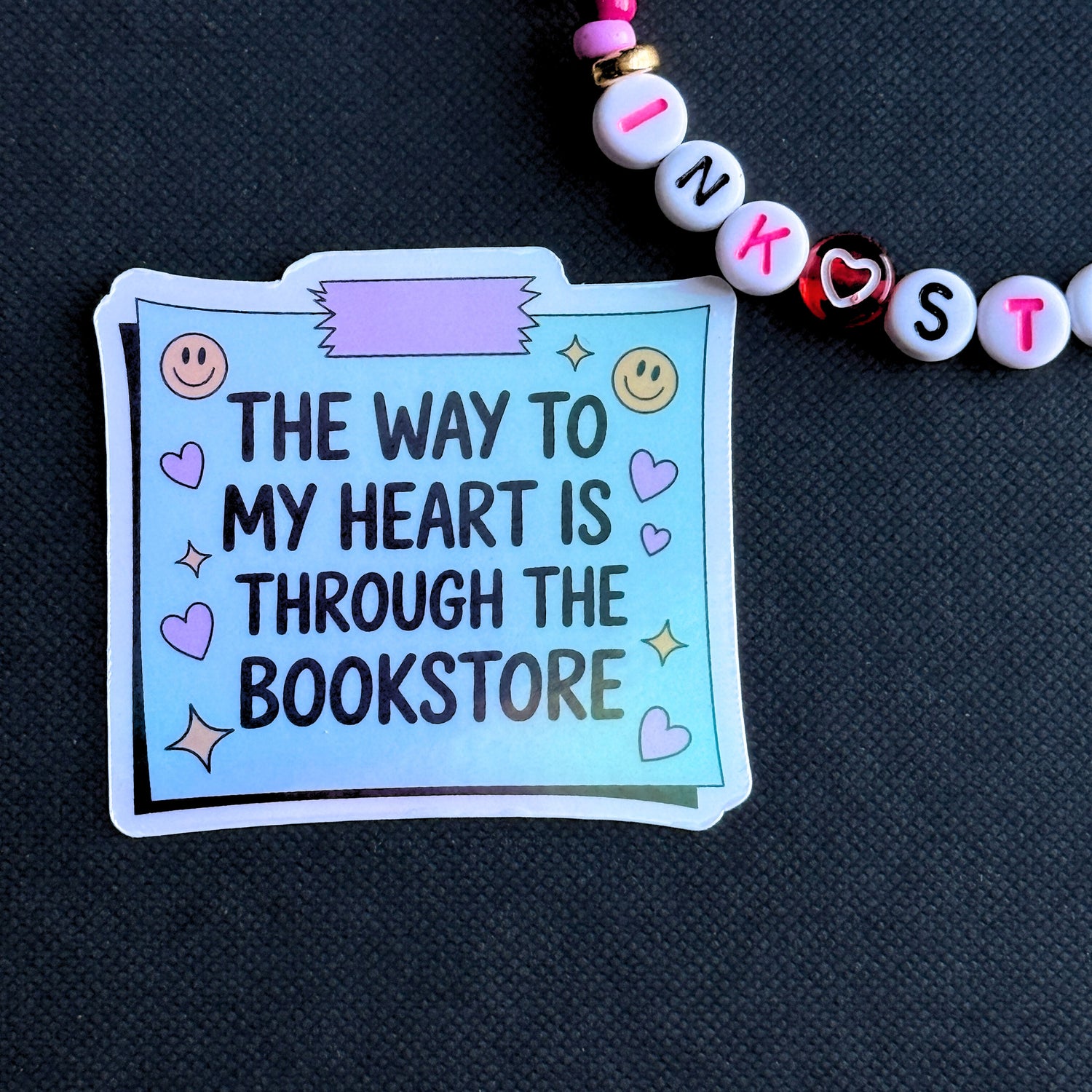 Sticker with text 'The way to my heart is through the bookstore' on a dark background