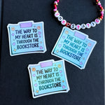 Three blue stickers with text on a black background, featuring a colorful beaded necklace.