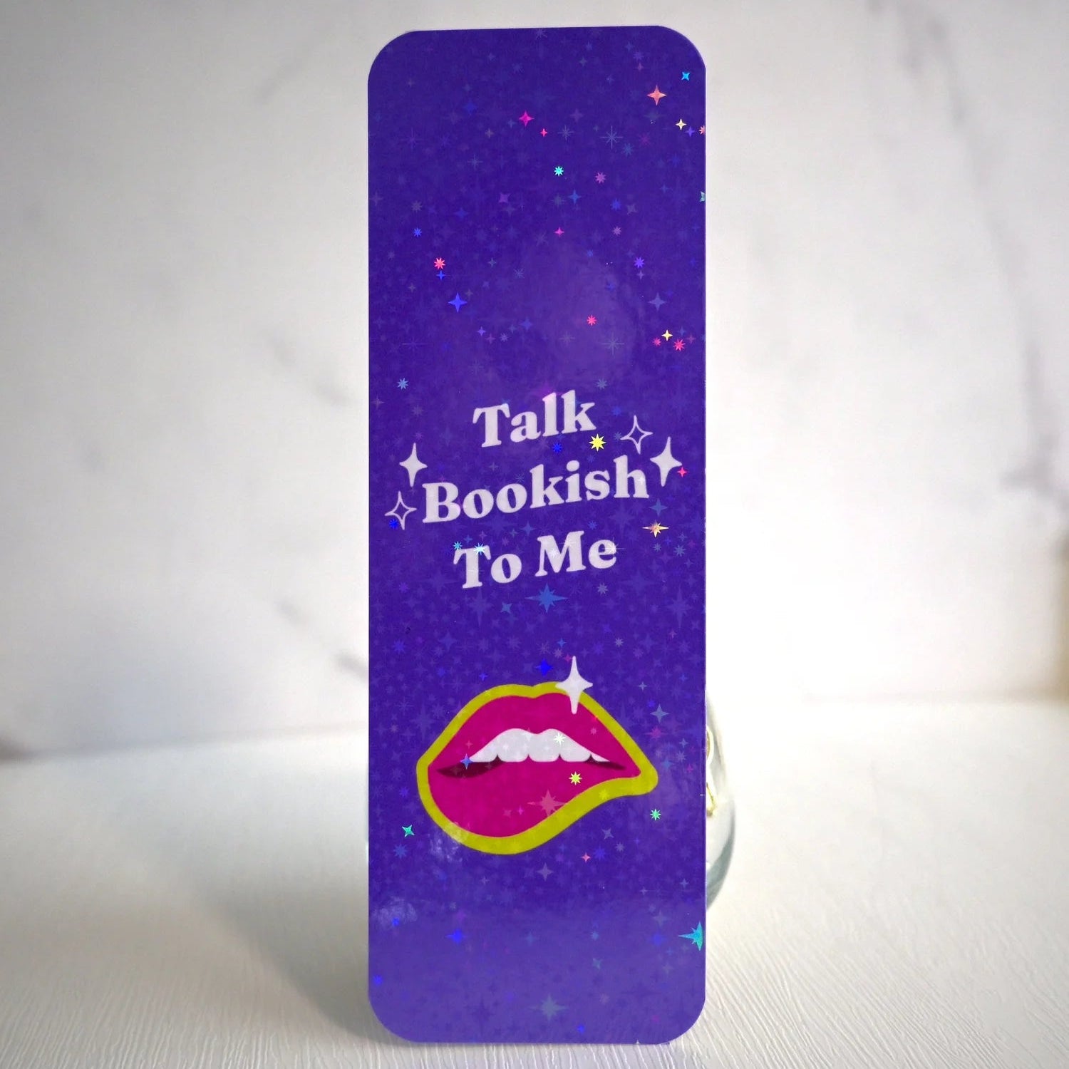 Purple bookmark with 'Talk Bookish To Me' text and lip graphic on a white background