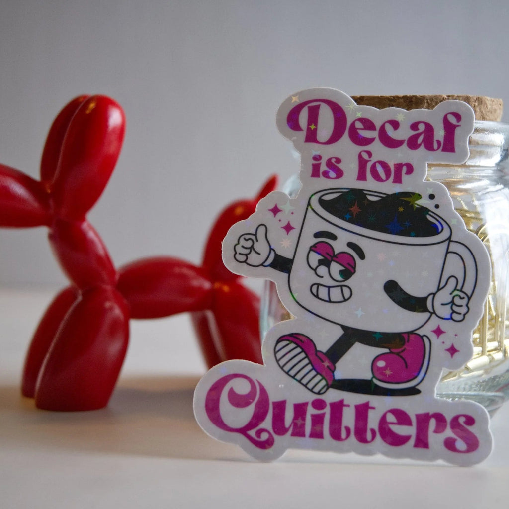 Jar with a cartoon character and text 'Decaf is for Quitters' next to a red balloon dog.