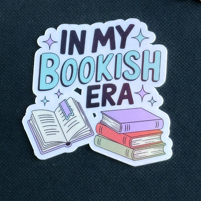 Sticker with 'In My Bookish Era' text and book illustrations on a dark background