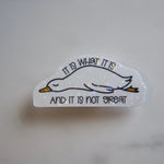 Sticker with a duck illustration and text on a marble surface