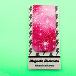 Magnetic bookmark with pink and white design on a green background
