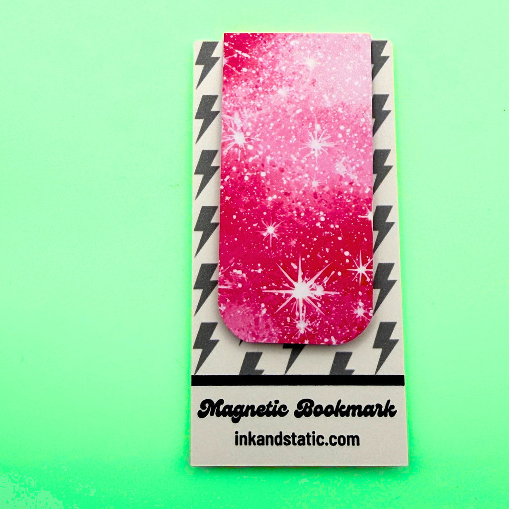 Magnetic bookmark with pink and white design on a green background