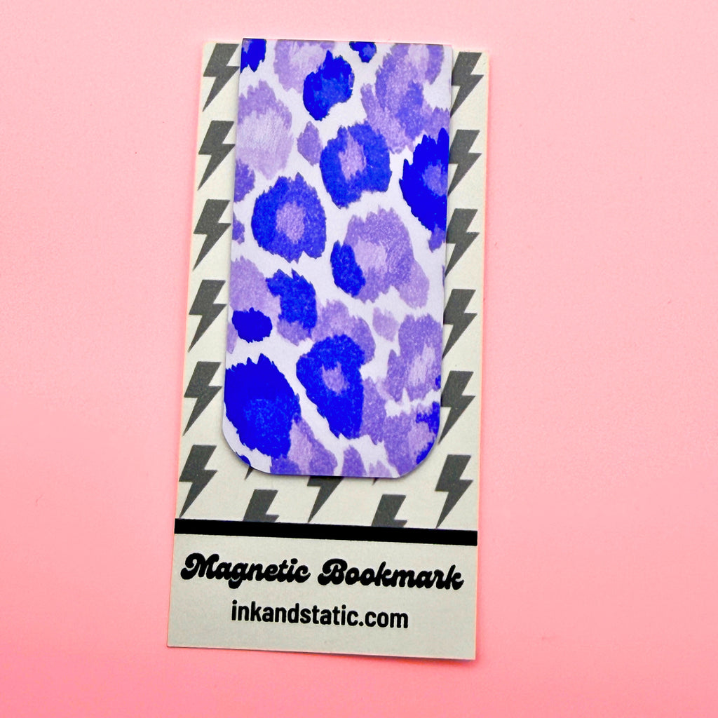 Magnetic bookmark with purple leopard print design on a pink background