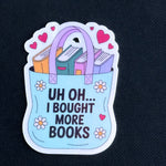 Sticker with a tote bag full of books and text 'Uh oh... I bought more books' on a black background