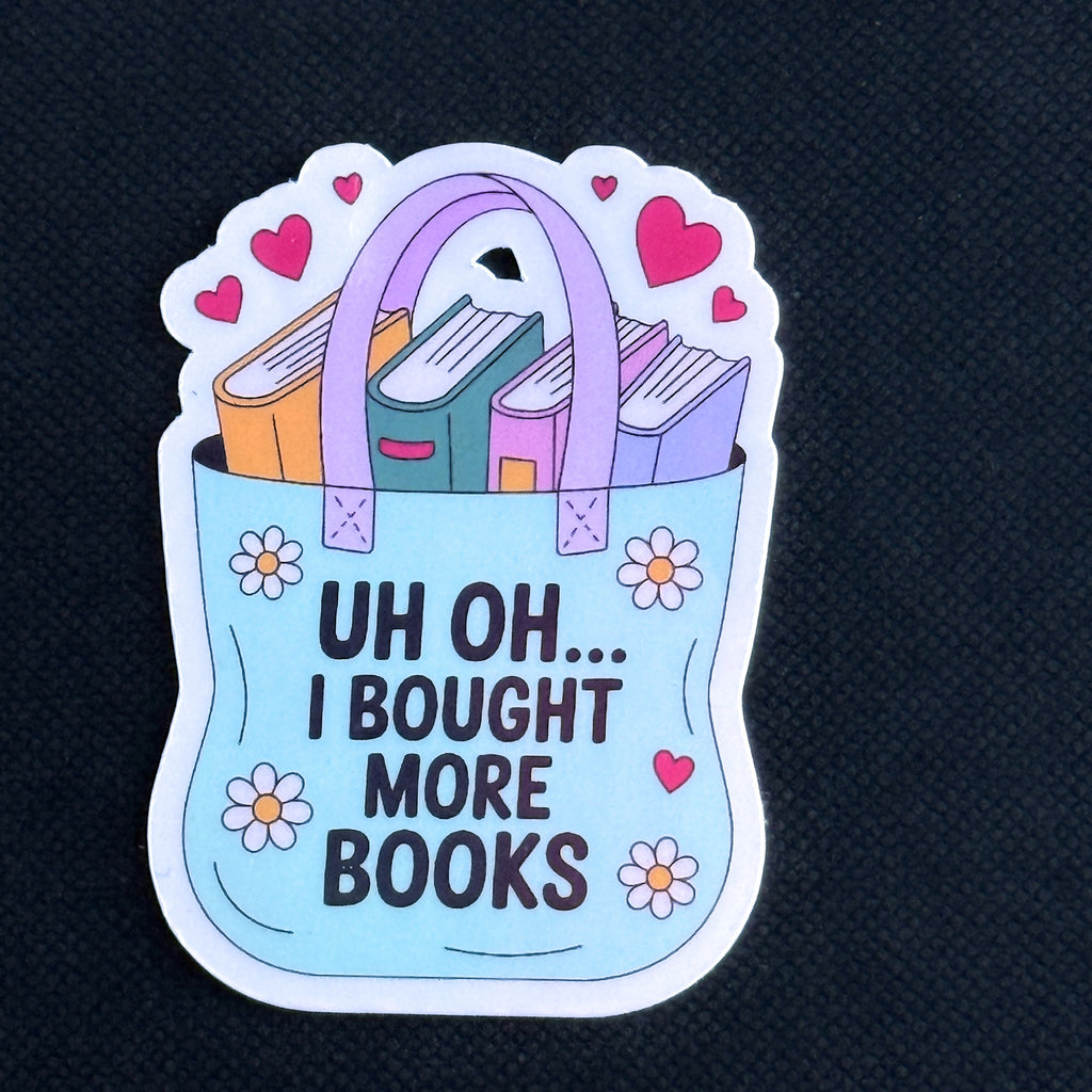 Sticker with a tote bag full of books and text 'Uh oh... I bought more books' on a black background