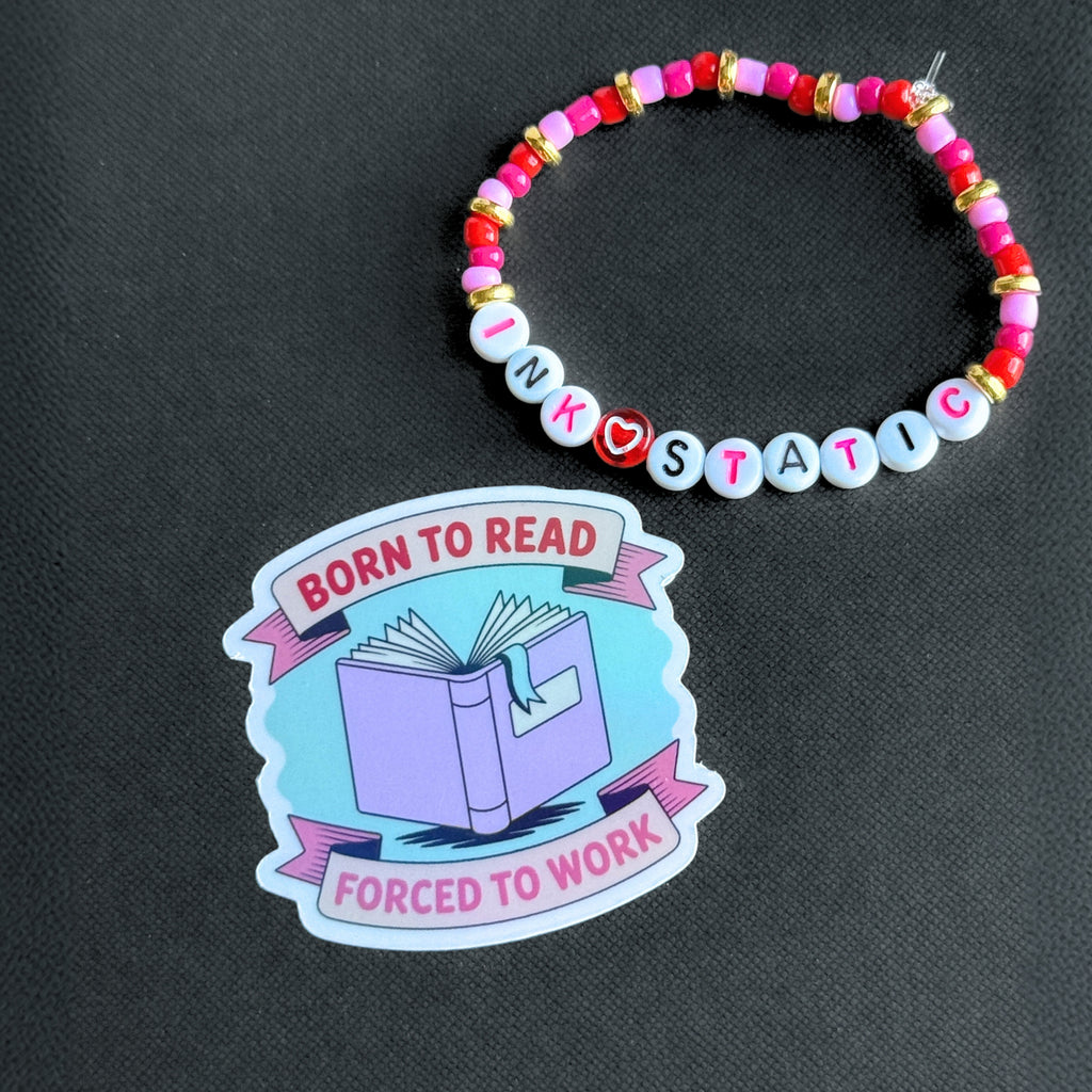 Colorful beaded bracelet and 'Born to Read' sticker on a black background